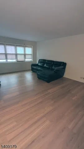 a view of wooden floor and windows in a room