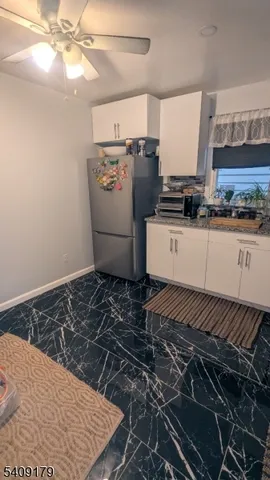 a room with water heater and wooden cabinets