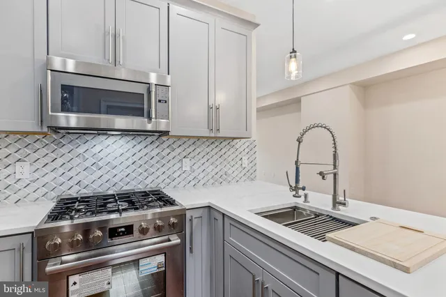 a kitchen with a stove and a sink