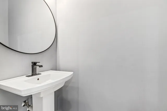a bathroom with a sink and mirror