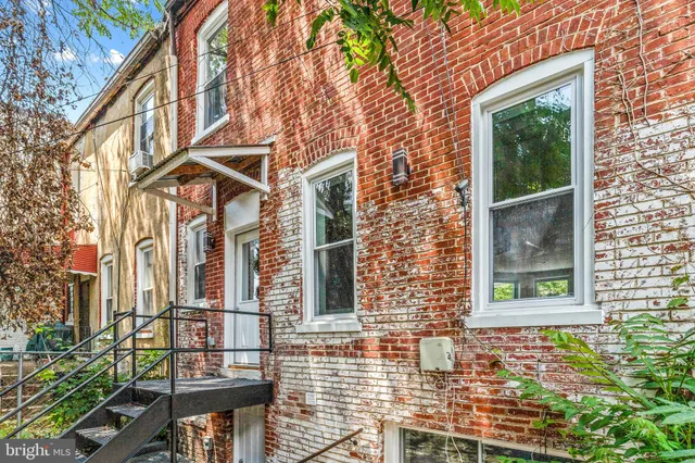 a view of a brick house with large windows