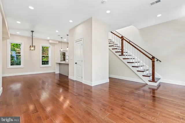 a view of an entryway with wooden floor and staircase