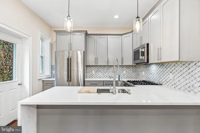 a kitchen with stainless steel appliances microwave and stove