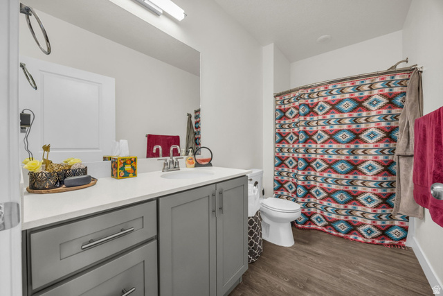 2101 North Main Street, Unit 409 Sunset, UT 84015 - Photo 13 of 18 Full bathroom featuring vanity, a shower with curtain, and dark wood-type flooring