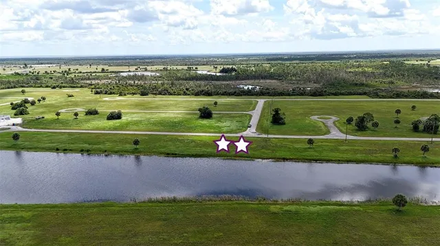 an aerial view of a golf course with a lake view
