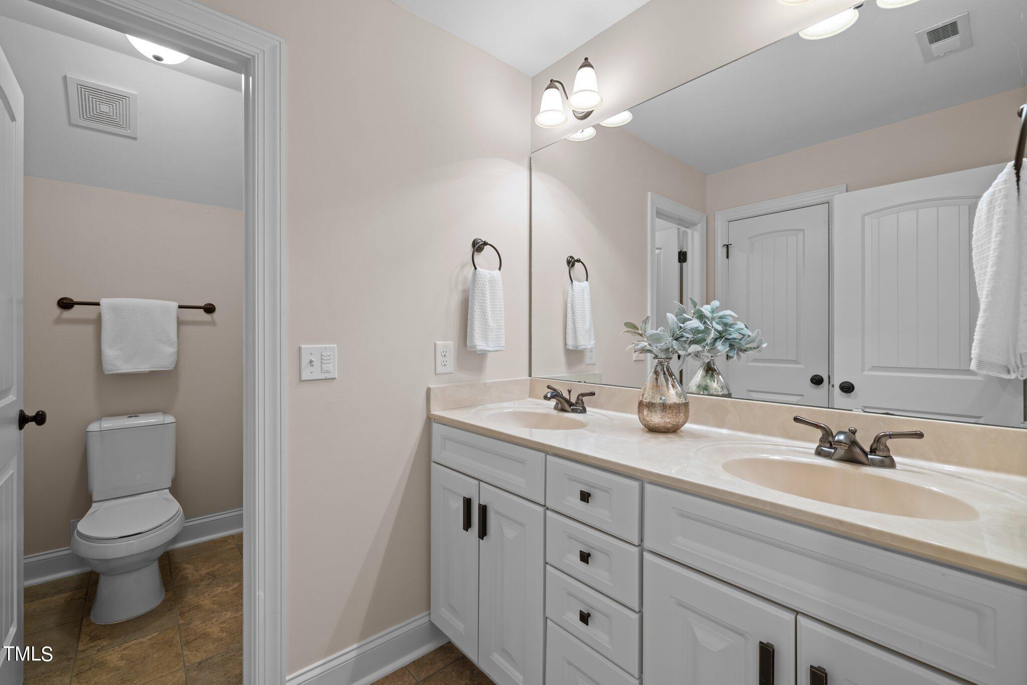 152 Roads End Pittsboro, NC 27312 - Photo 31 of 58 a bathroom with a toilet a sink and mirror