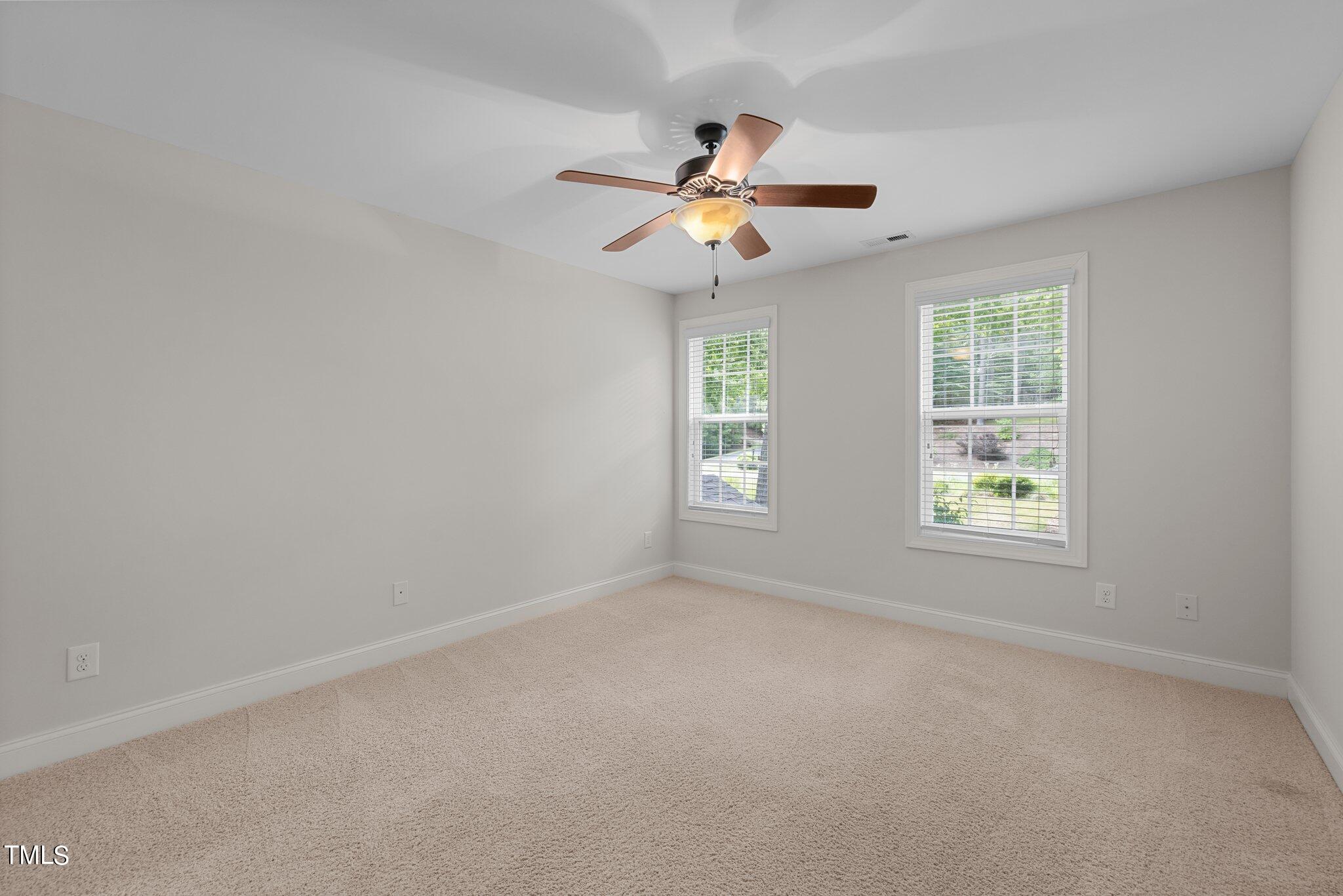 152 Roads End Pittsboro, NC 27312 - Photo 33 of 58 an empty room with windows and fan