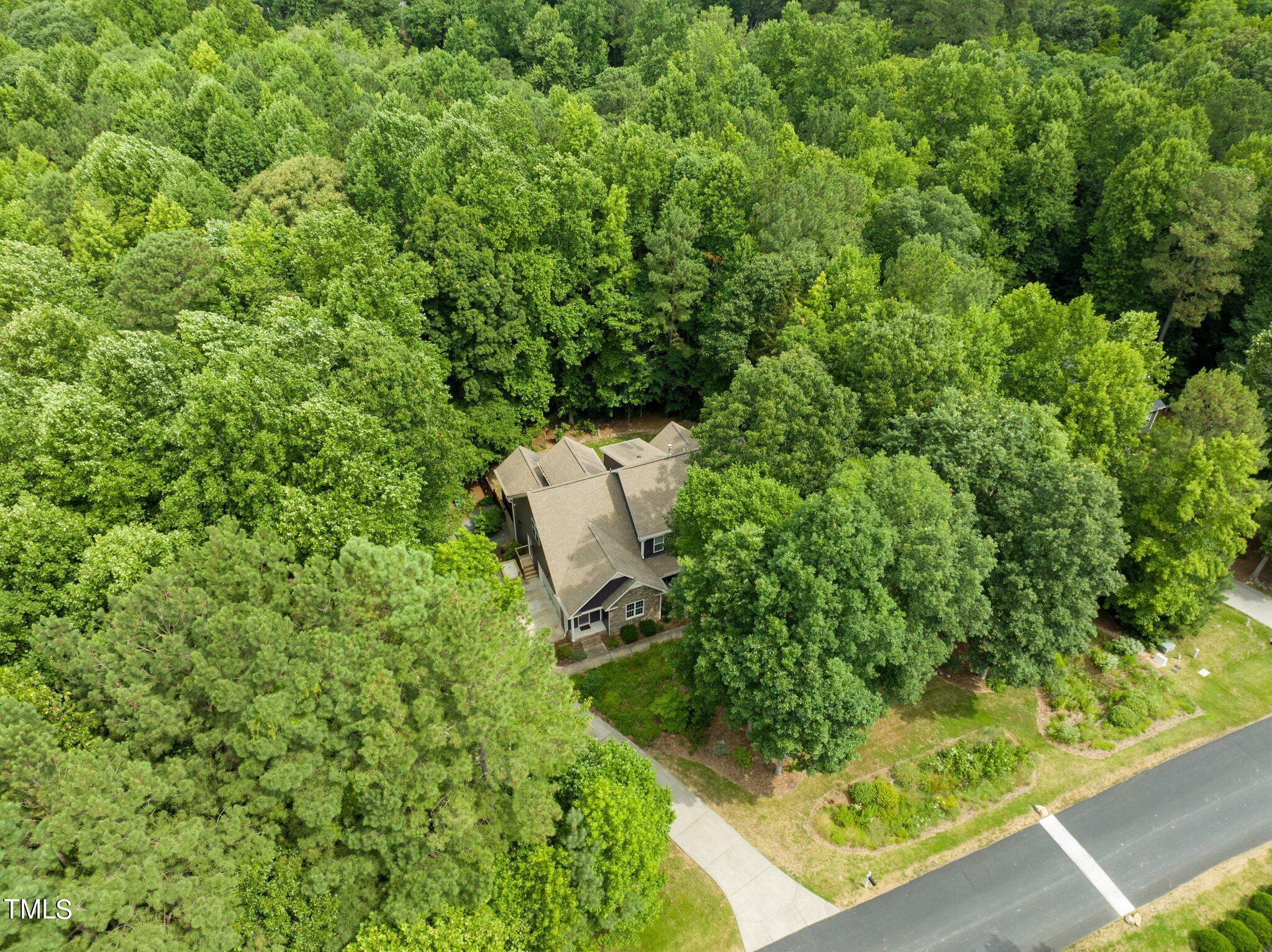 152 Roads End Pittsboro, NC 27312 - Photo 56 of 58 a view of a garden with a bench