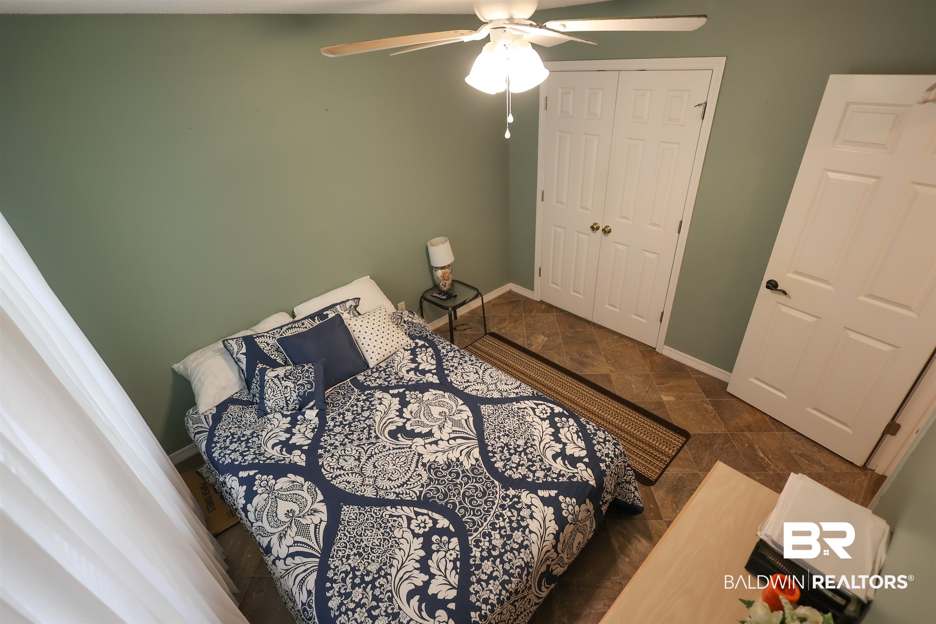 7790 Audubon Drive Foley, AL 36535 - Photo 28 of 39 Room featuring neutral wall paint, tiled flooring, a ceiling fan with integrated lighting, and a double-door closet