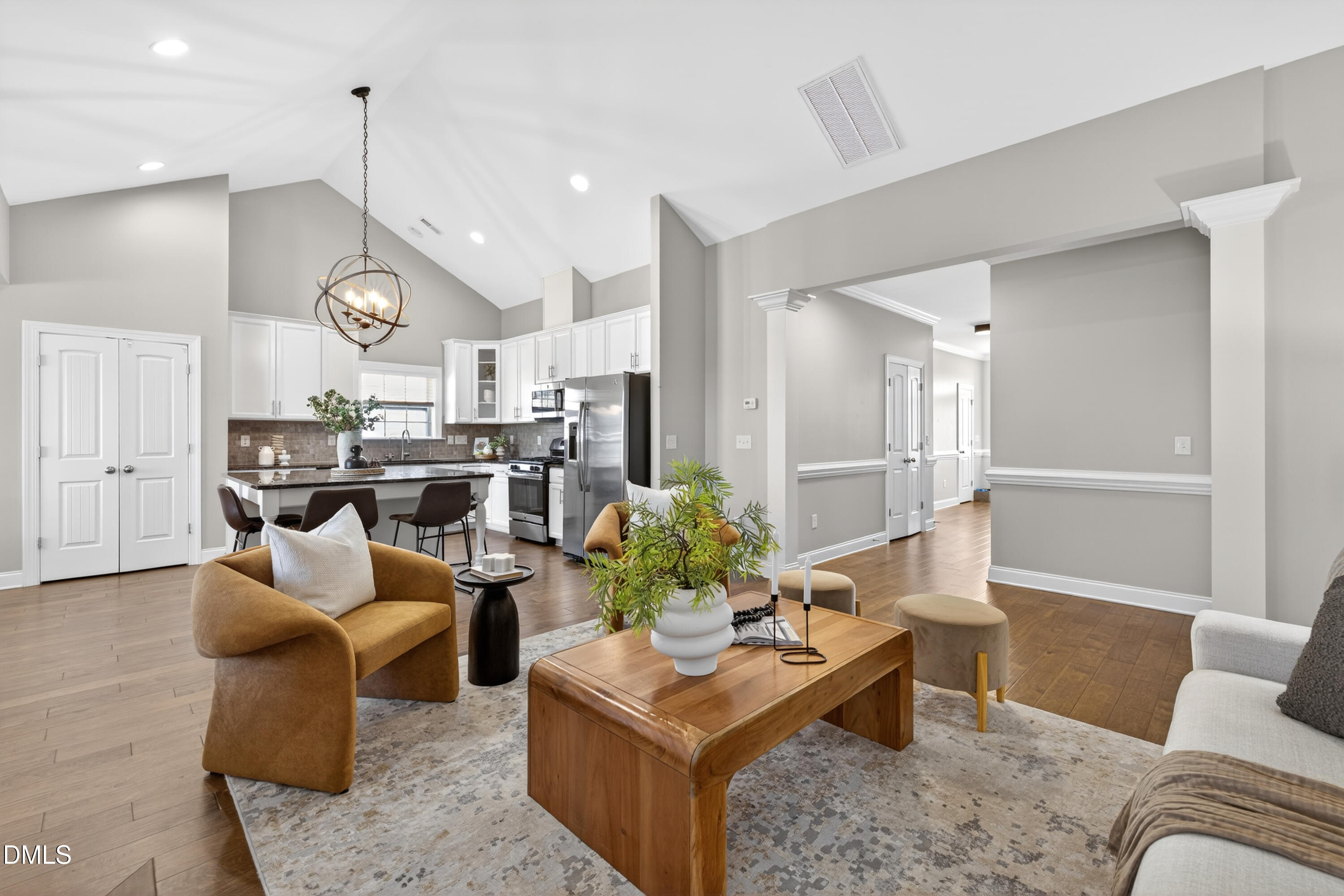5248 Copain Cove Fuquay-Varina, NC 27526 - Photo 10 of 47 a living room with furniture kitchen view and a chandelier