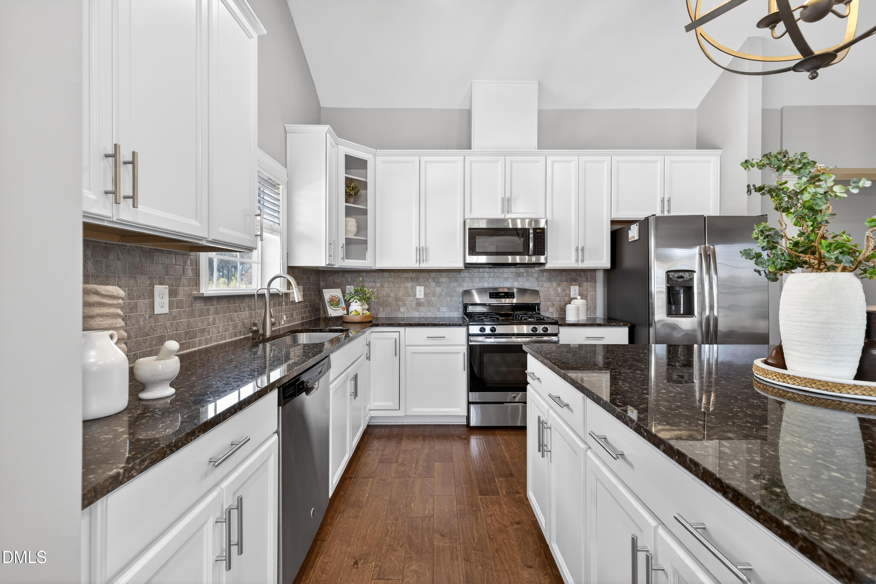 5248 Copain Cove Fuquay-Varina, NC 27526 - Photo 12 of 47 a kitchen with stainless steel appliances granite countertop a sink a stove and a refrigerator