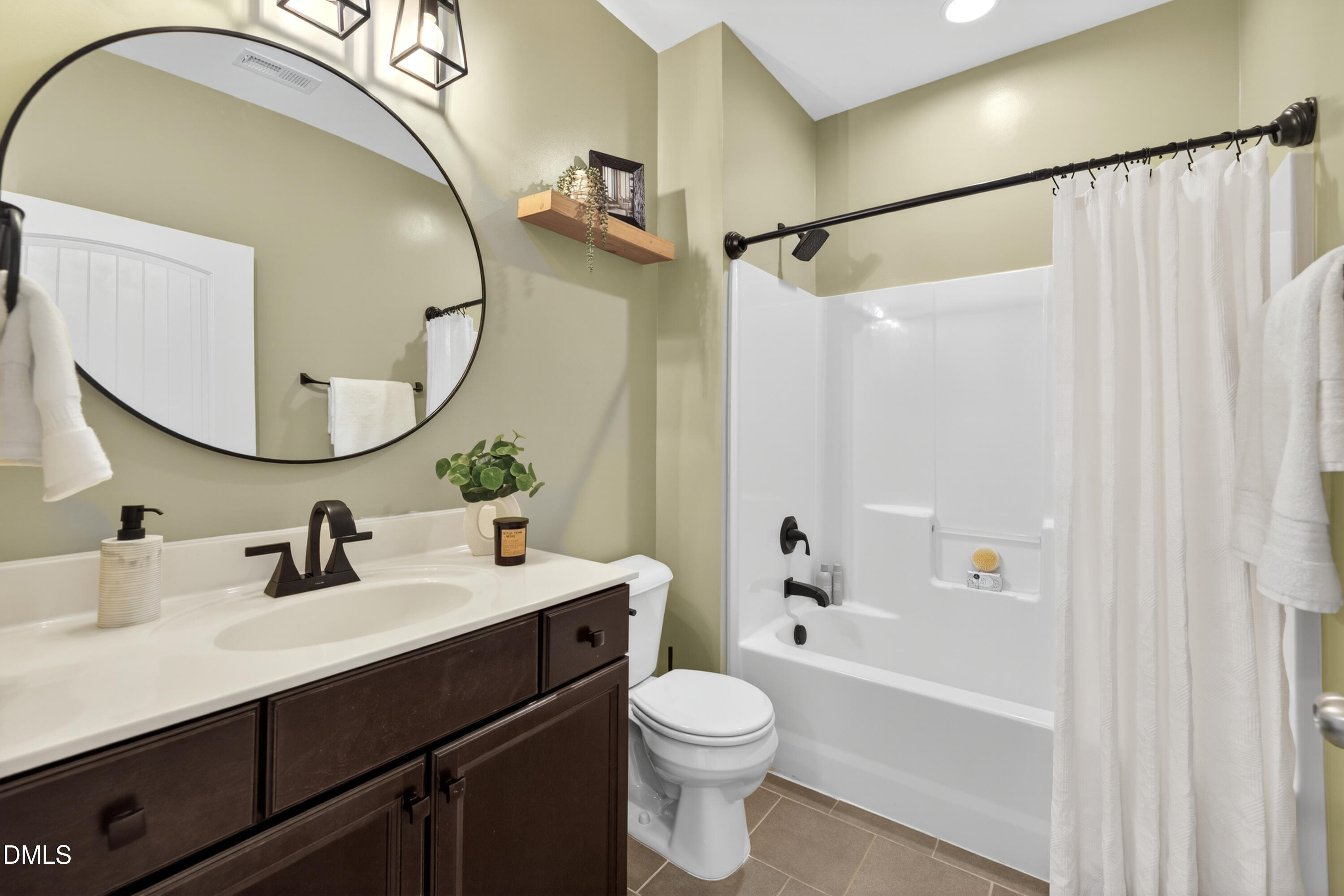 5248 Copain Cove Fuquay-Varina, NC 27526 - Photo 29 of 47 a bathroom with a sink mirror toilet and bathtub
