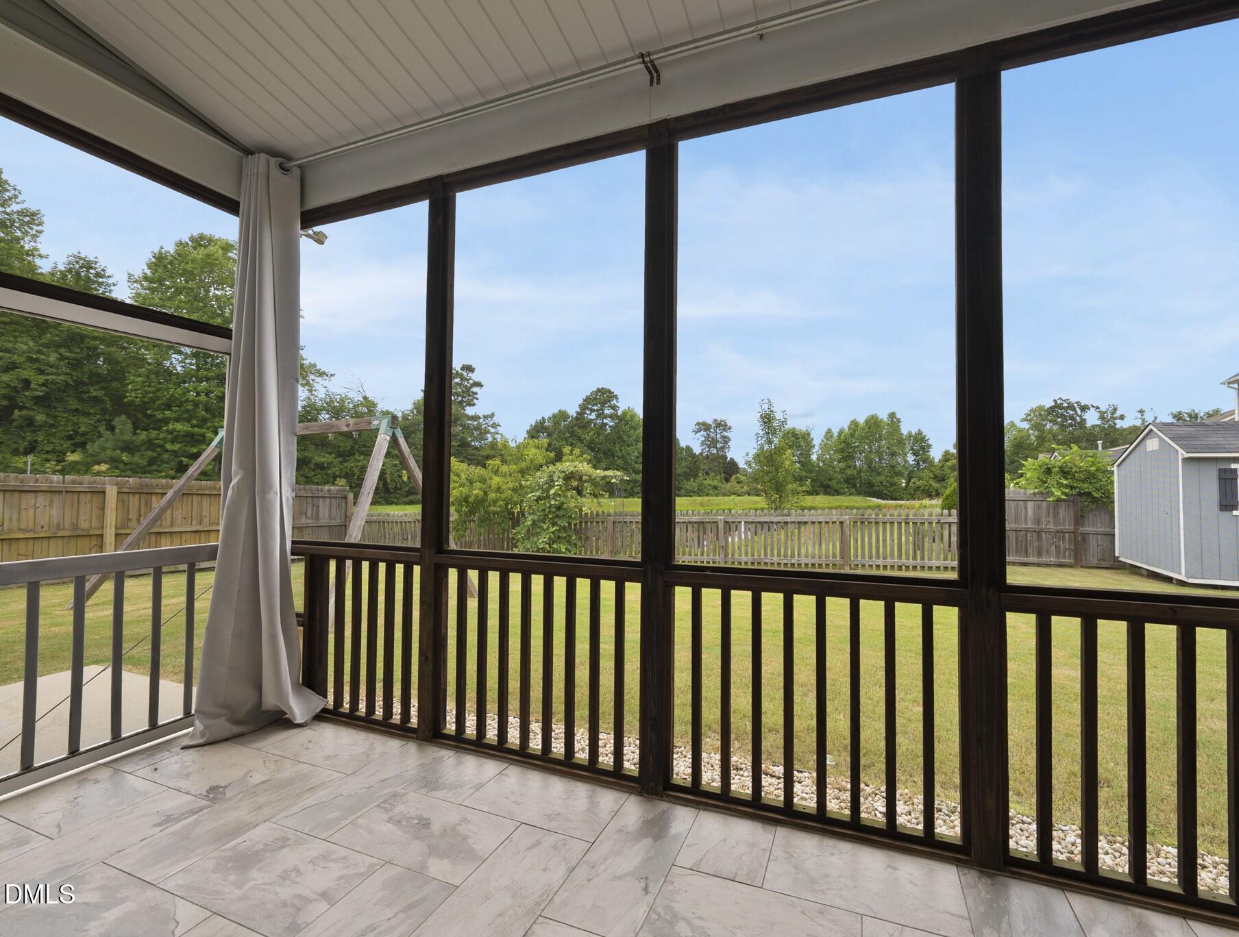 5248 Copain Cove Fuquay-Varina, NC 27526 - Photo 34 of 47 a view of a porch with a floor to ceiling window