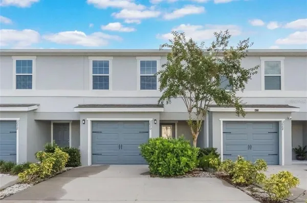 front view of a house with potted plants