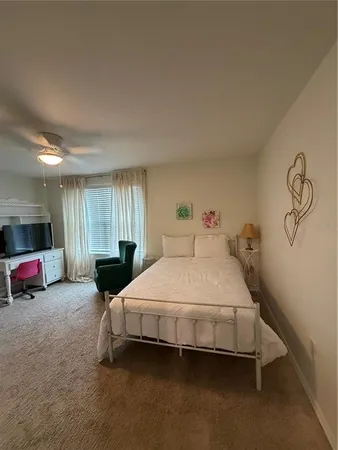 a spacious bedroom with a bed and a car