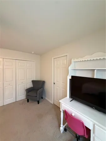 a living room with a bed furniture and a fireplace