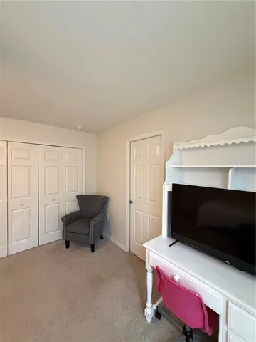 a living room with a bed furniture and a fireplace