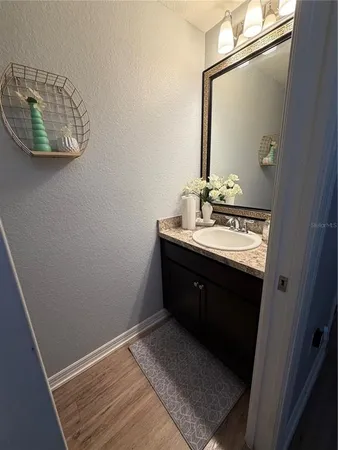 a bathroom with a sink vanity and a mirror