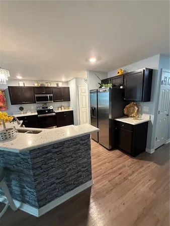 a kitchen with kitchen island and a sink
