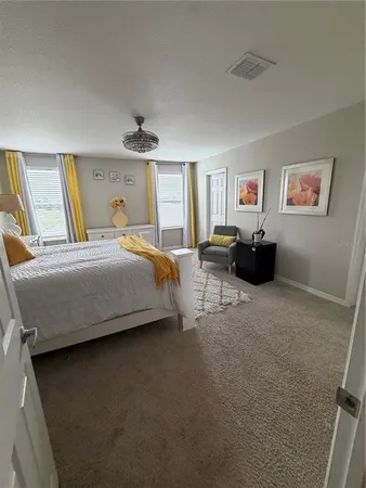 a bedroom with a bed couch and window