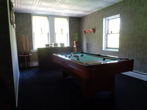 a living room with dining table and a window