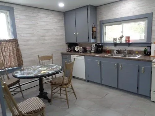 a kitchen with a sink cabinets and window