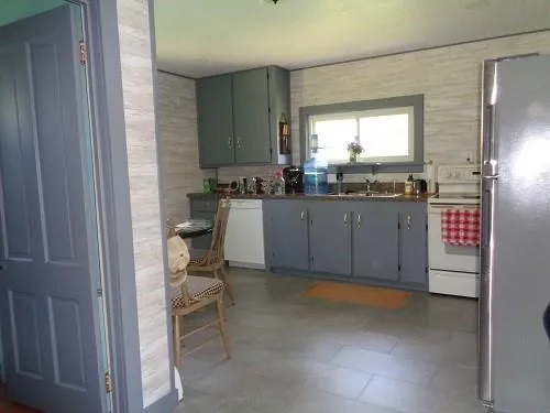 a kitchen with cabinets and chairs