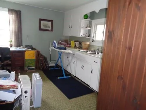 a kitchen with a sink appliances and cabinets