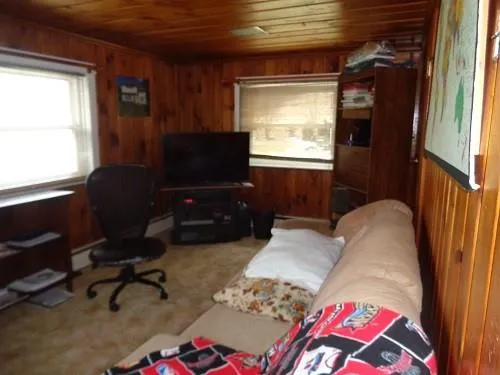 a livingroom with workspace and a window