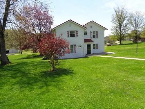 a front view of house with yard and green space