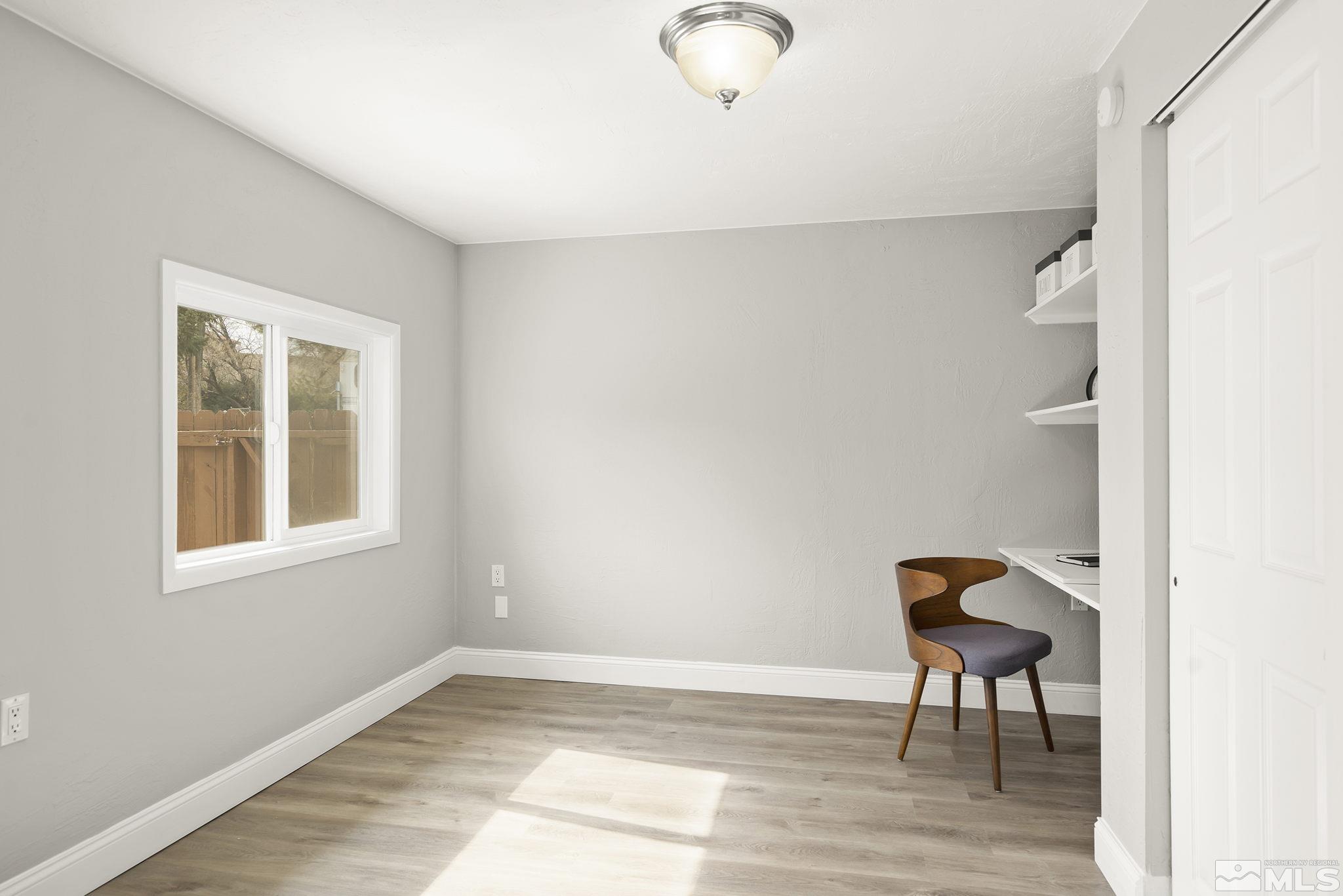 8895 Limnol Street Reno, NV 89506 - Photo 12 of 21 a view of a livingroom with wooden floor and a window