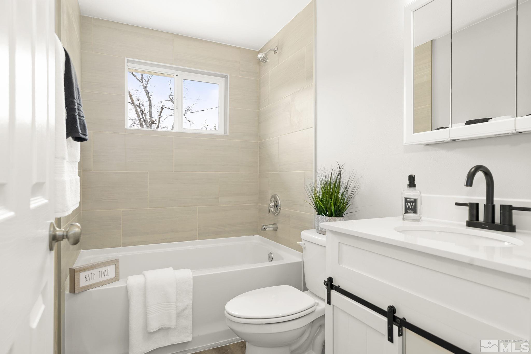 8895 Limnol Street Reno, NV 89506 - Photo 16 of 21 a bathroom with a sink a toilet and a bathtub
