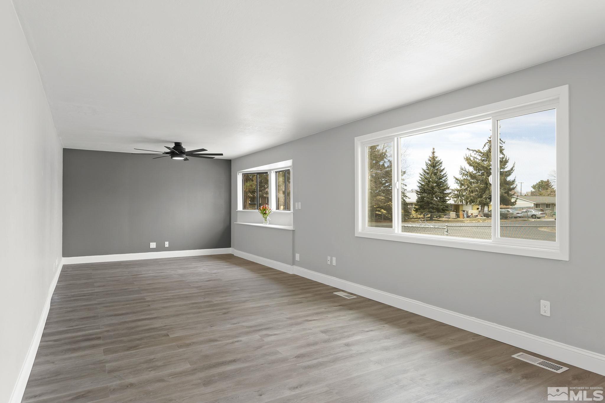 8895 Limnol Street Reno, NV 89506 - Photo 4 of 21 a view of an empty room with a window and wooden floor