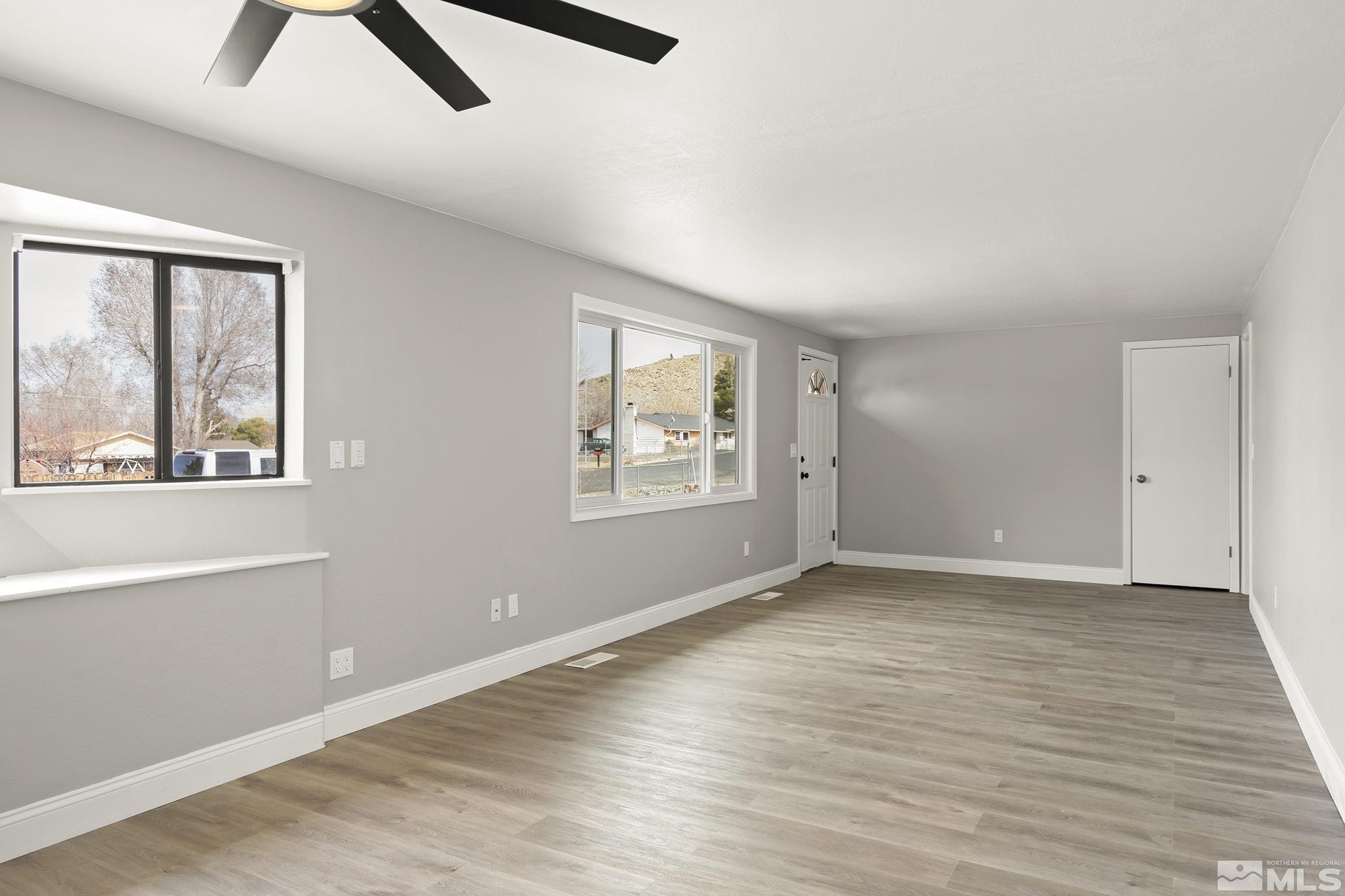 8895 Limnol Street Reno, NV 89506 - Photo 6 of 21 wooden floor in an empty room with a window