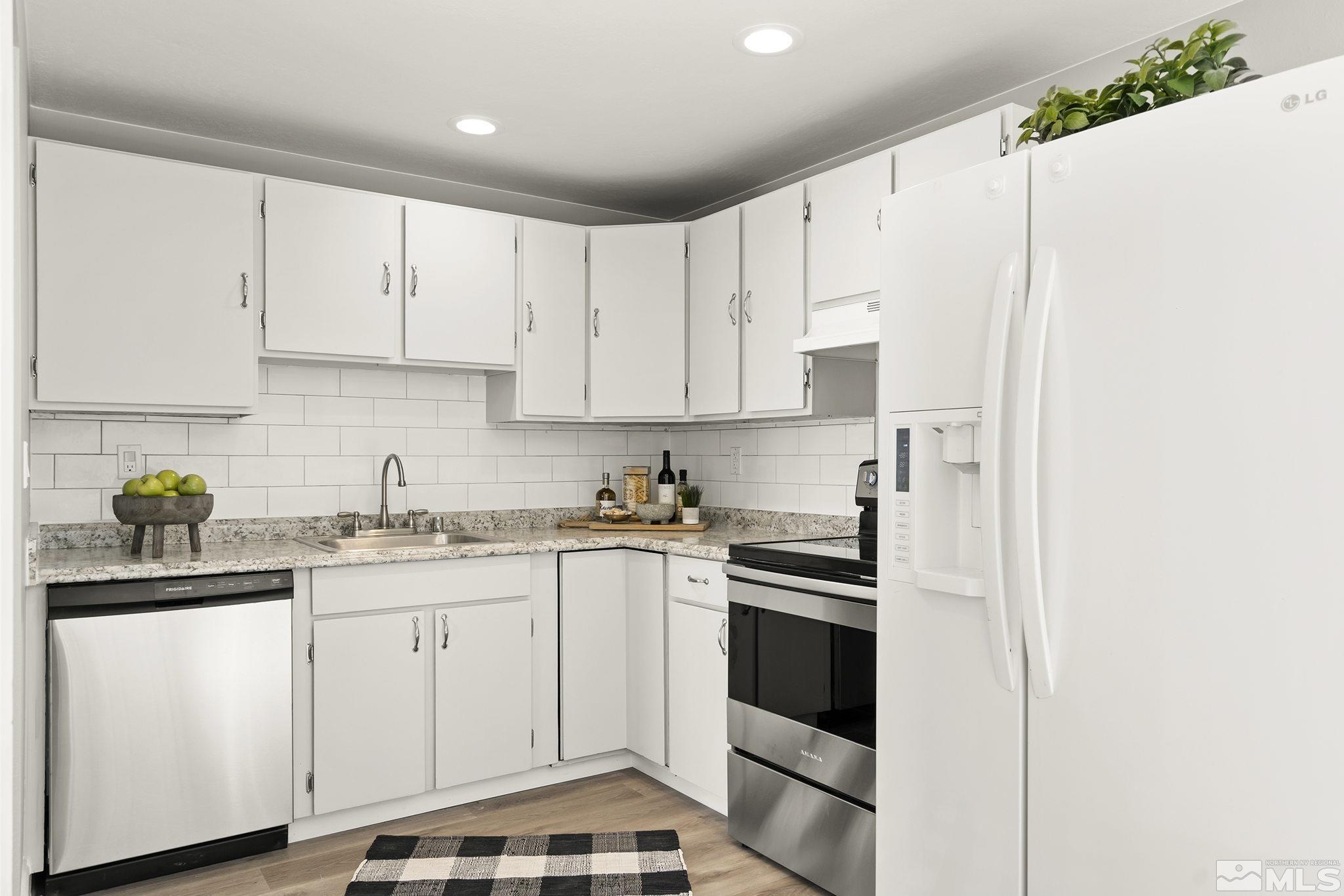 8895 Limnol Street Reno, NV 89506 - Photo 8 of 21 a kitchen with cabinets appliances and a sink