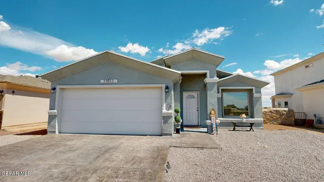 a view of a house with a yard and garage