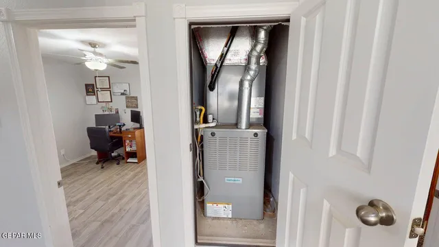 a bed sitting in a bedroom next to a window with a mirror