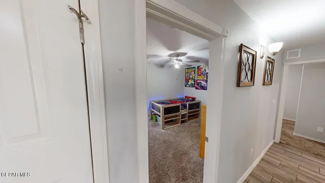 a bedroom with a bed and a painting on the wall