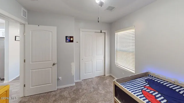 a bedroom with a bed and flat screen tv