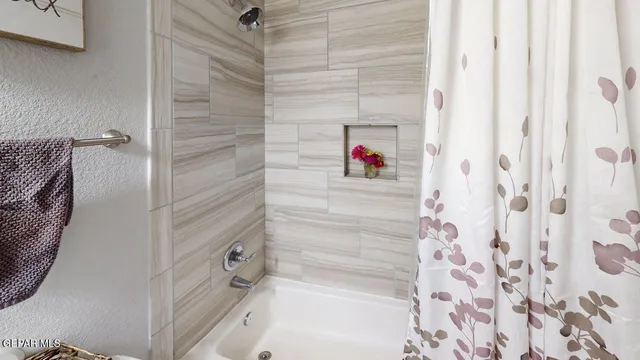 a bathroom with a shower and a glass door