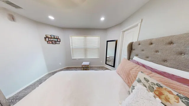 a view of a hallway with a livingroom with furniture and windows