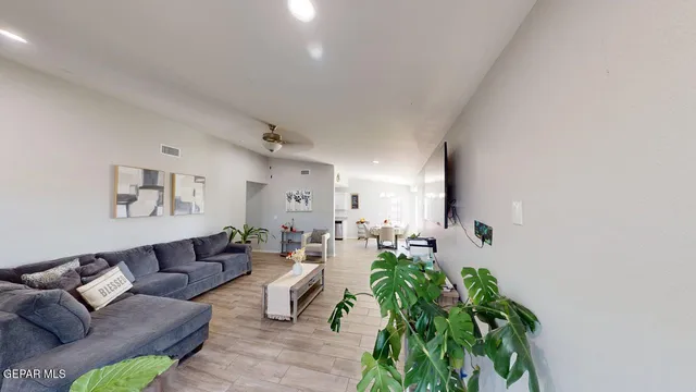 a living room with furniture and a wooden floor