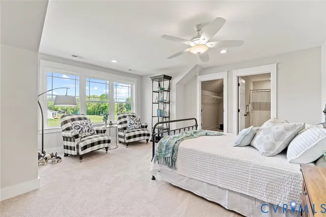 a bedroom with furniture and large windows