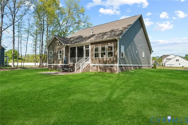 a front view of house with yard and outdoor seating