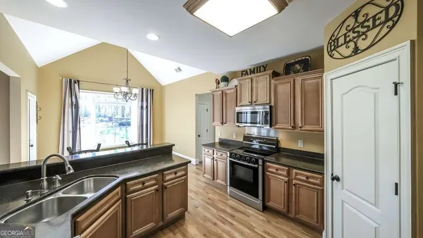 a kitchen with stainless steel appliances a sink stove and refrigerator