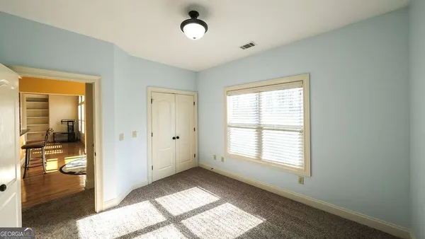 a view of an empty room with glass door