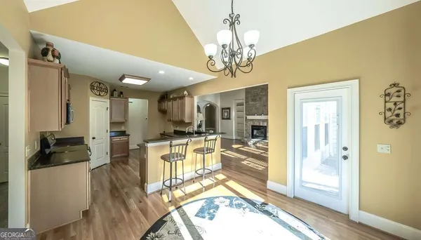 a view of a dining room with furniture a chandelier and wooden floor