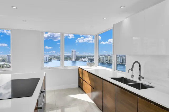 a kitchen with a sink a stove and cabinets