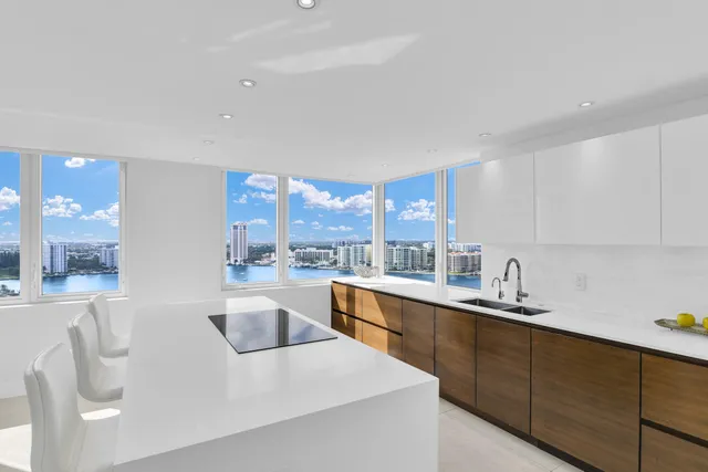 a kitchen with a sink cabinets and a large window