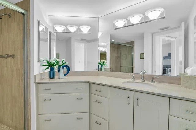 a bedroom with a bed and a large window with outer view